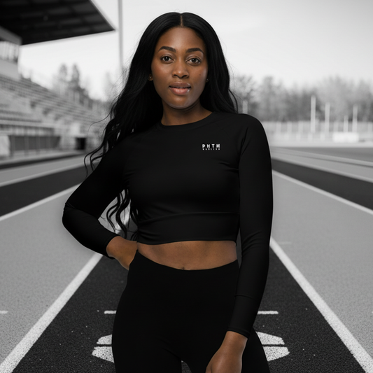 Woman wearing a black athletic outfit with a logo on a track background