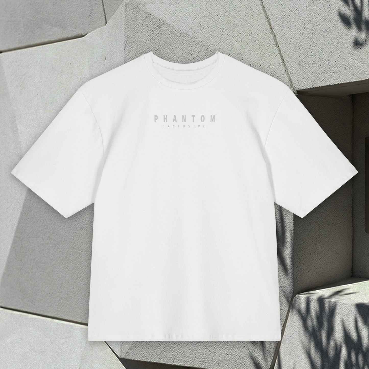 White t-shirt with 'PHANTOM' branding on a textured surface